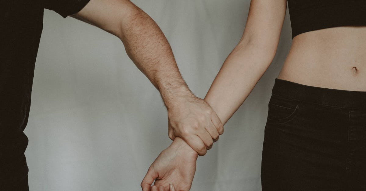 What's the difference between a grab and a command grab? [closed] - Unrecognizable aggressive man seizing hand of vulnerable helpless woman while standing on white background during domestic violence in light room