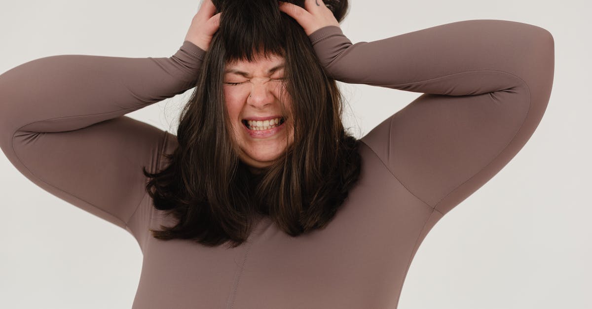 What's the difference between a grab and a command grab? [closed] - Young obese woman rumpling hair with closed eyes in white studio