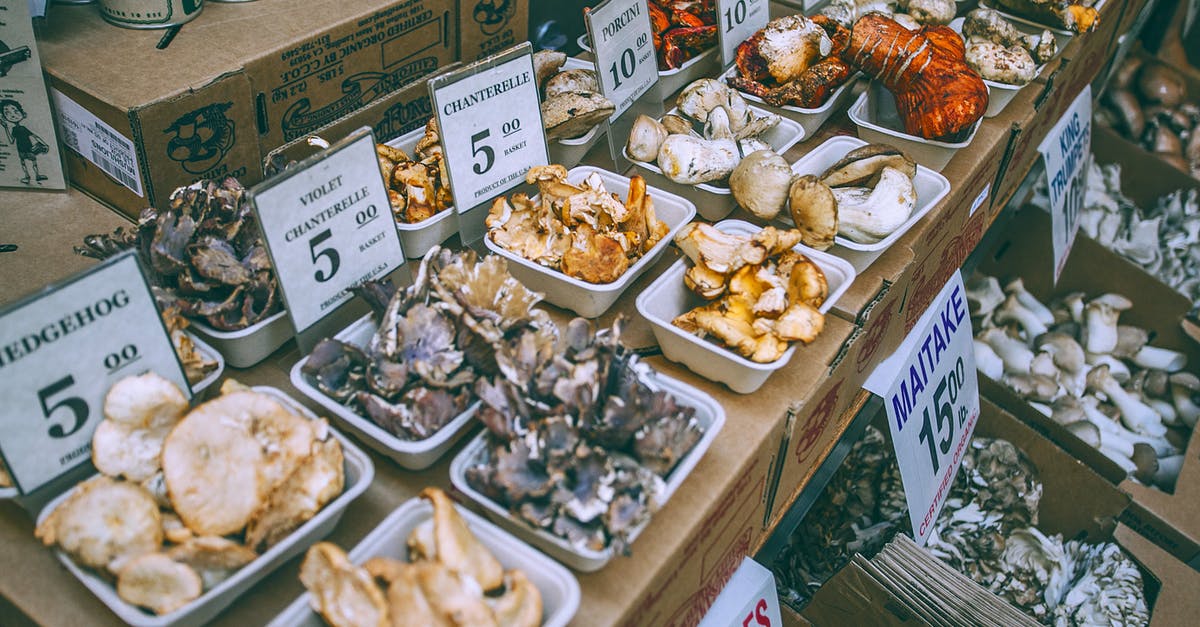 What's the difference between different priced chests? - Assorted mushrooms on counter in market