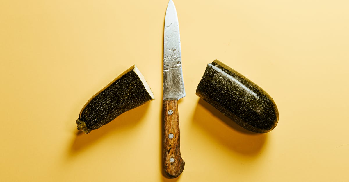 What's the difference between life, health, armour and shield? - From above of fresh sliced zucchini placed on yellow background with sharp knife with wooden handle between halves of vegetable