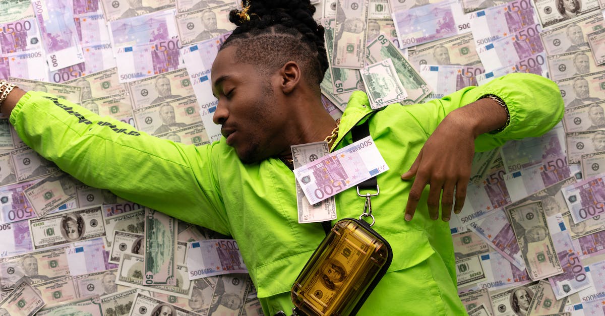 What's the fastest way to make money in Sleeping Dogs? - Man in Green Jacket Lying Down on Money