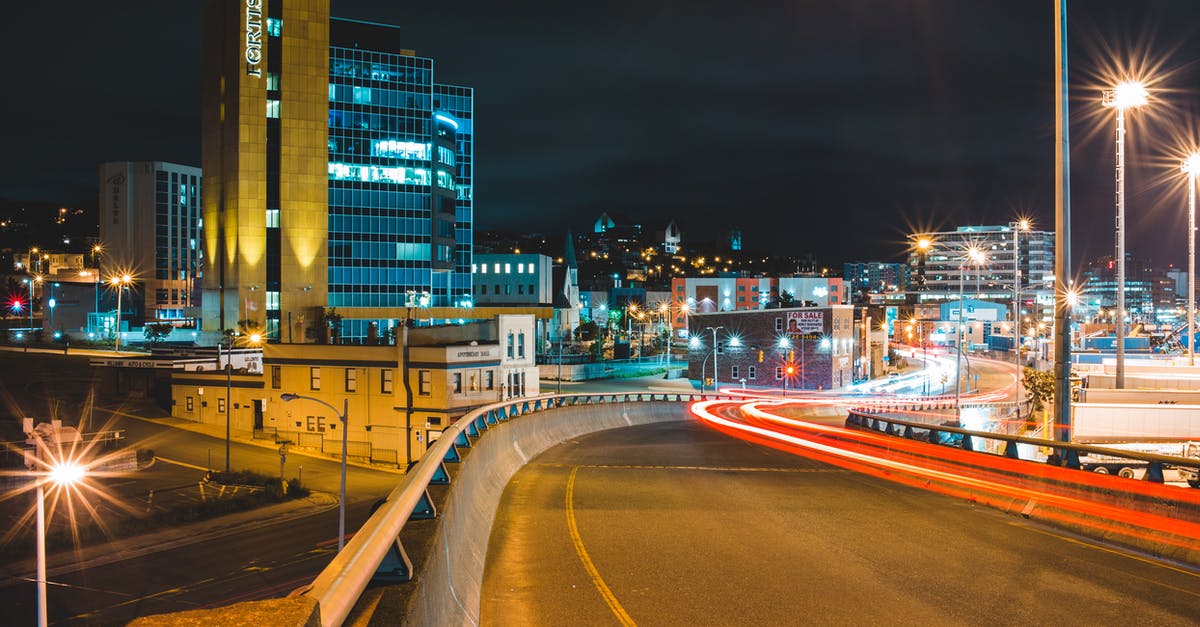What's the FTL drive my empire uses in Stellaris? - Illuminated asphalt roadway with traffic near contemporary high buildings in downtown of night city