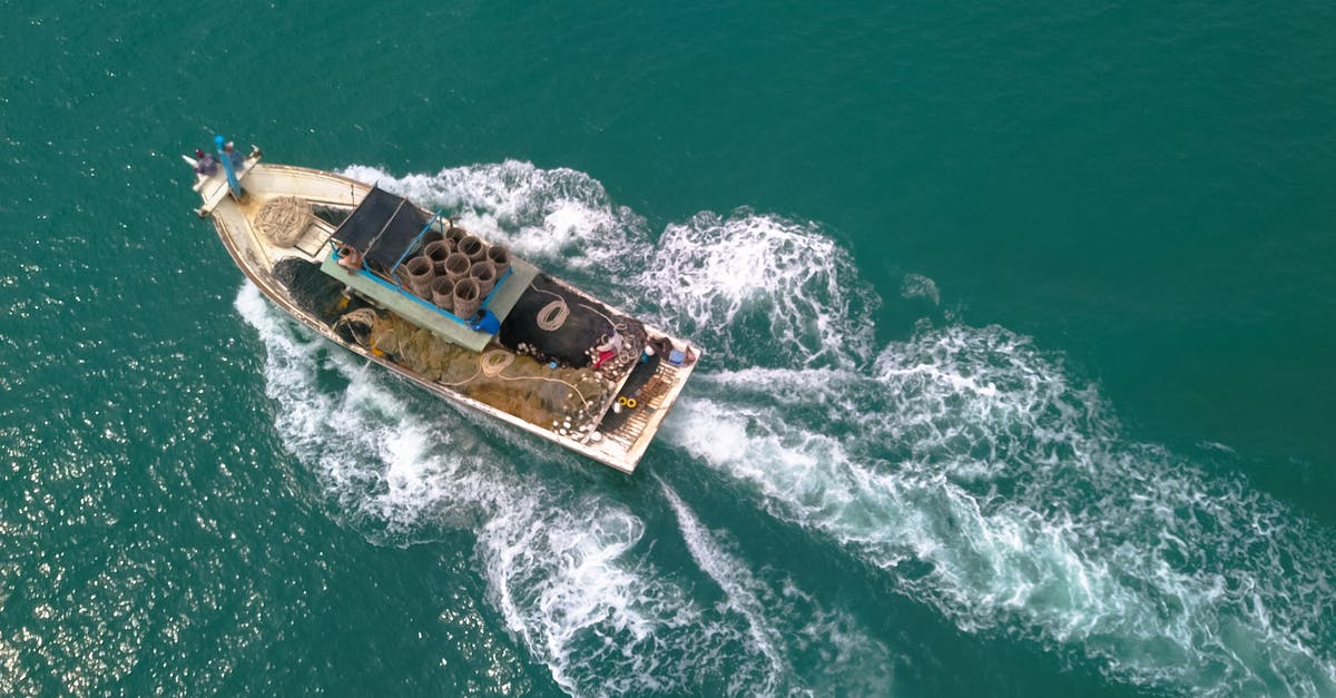 What's the maximum speed that is still considered walking? [duplicate] - Drone view of boat with open deck and fishing equipment floating on calm sea at daytime
