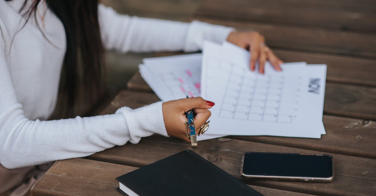 What's the meaning of a highlighted side ops with a dot on the left side? - Side view of crop unrecognizable ethnic female office employee working with papers representing month plan