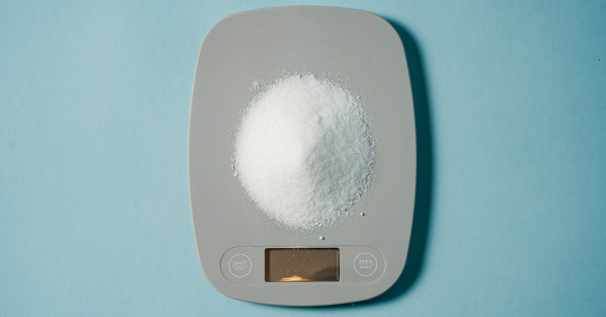 What's the most efficient food source to keep my hunger and thirst levels in check in Survival? - Top view of kitchen scales with electronic display measuring weight of sugar on blue background