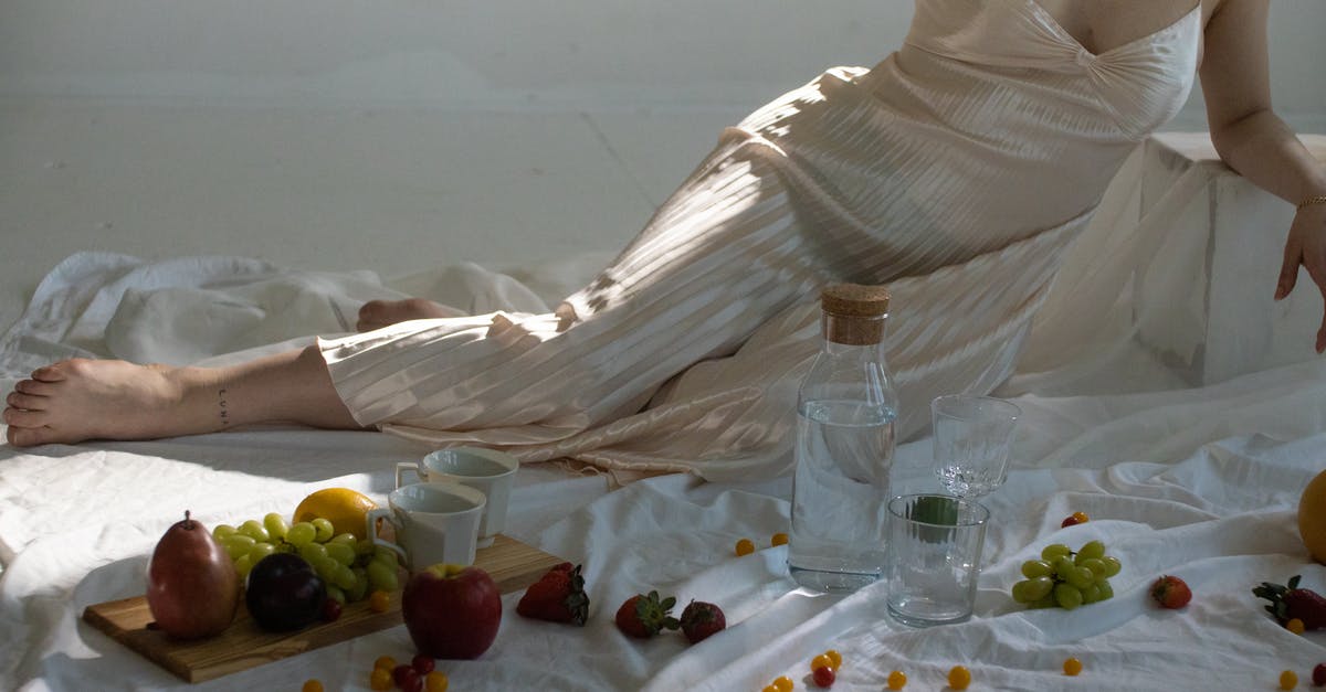 What's the most efficient food source to keep my hunger and thirst levels in check in Survival? - Woman resting near glassware and sweet fruits on wooden board