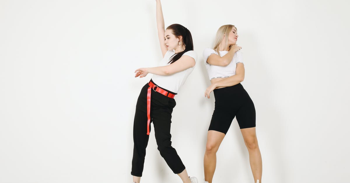 What's the non-poking action that makes Partner Eevee sad? - Young female dancers in sportswear and sneakers making dancing movements while standing on concrete floor in studio near white wall