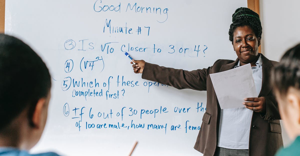 What's the point of Assignments? - Positive black teacher pointing at tasks on whiteboard