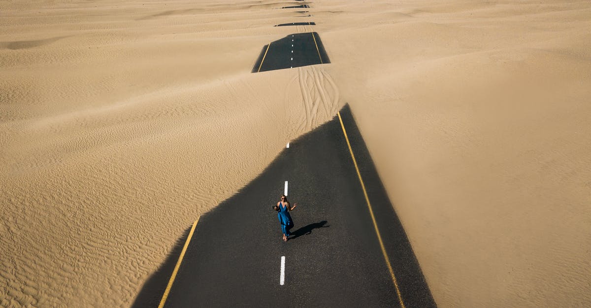What's the purpose of elite caravans in the desert - Bird's Eye View Photography of Road in the Middle of Desert