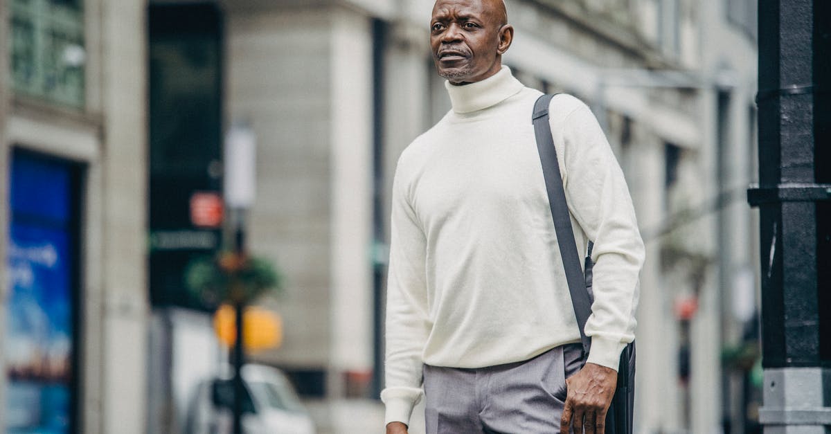 What abilities are available to a Leader from the Leader mod? - Low angle of confident African American businessman in trendy outfit standing on street in downtown