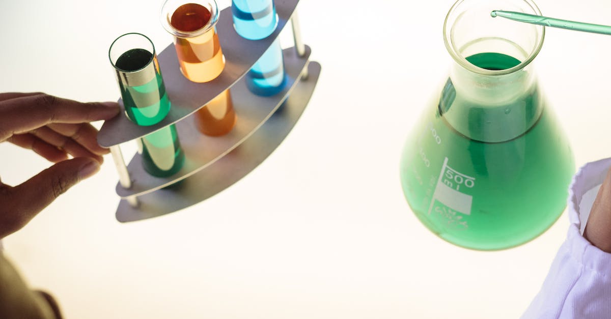 What actions result in gaining DNA? - Crop laboratory technician examining interaction of chemicals in practical test modern lab What actions result in gaining DNA? - Crop laboratory technician examining interaction of chemicals in practical test modern lab