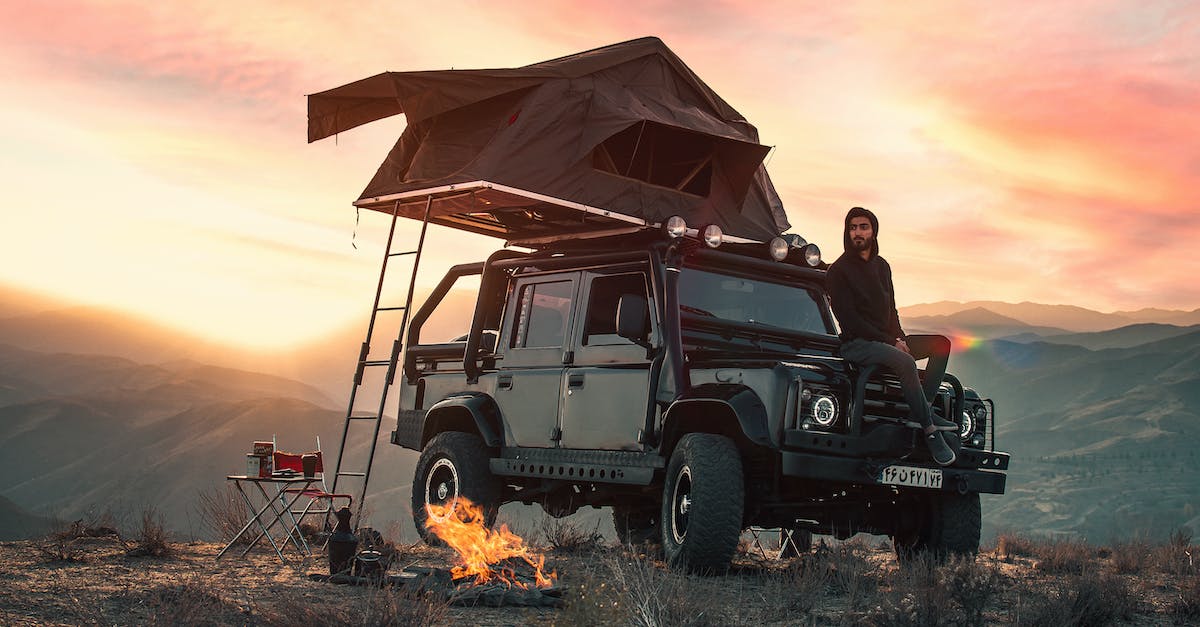 What activates auto fire? - Adult ethnic man sitting on offroad vehicle while resting in mountains What activates auto fire? - Adult ethnic man sitting on offroad vehicle while resting in mountains