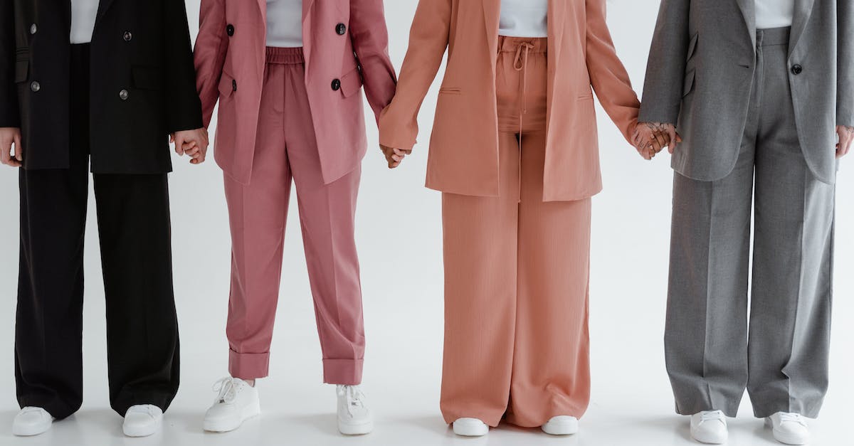 What actually unlocked the Previous Assassin's outfits - People Wearing Blazers and Pants Holding Hands while Standing Together