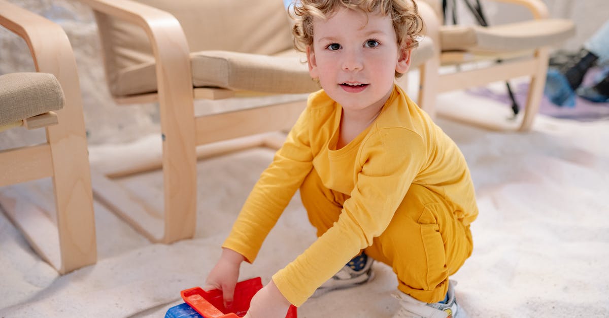 What advantages are there to playing with a locked camera? - A Cute Boy Playing with His Toy while Looking at Camera What advantages are there to playing with a locked camera? - A Cute Boy Playing with His Toy while Looking at Camera
