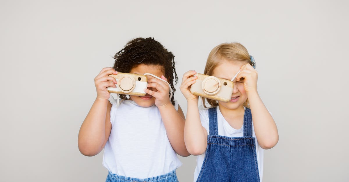 What advantages are there to playing with a locked camera? - Two Kids Taking Photo Using a Camera What advantages are there to playing with a locked camera? - Two Kids Taking Photo Using a Camera