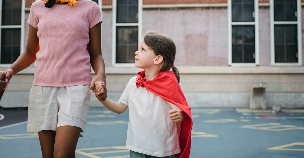 What age is appropriate for playing Roblox? - Girl in Pink Shirt and White Shorts Holding Red Umbrella