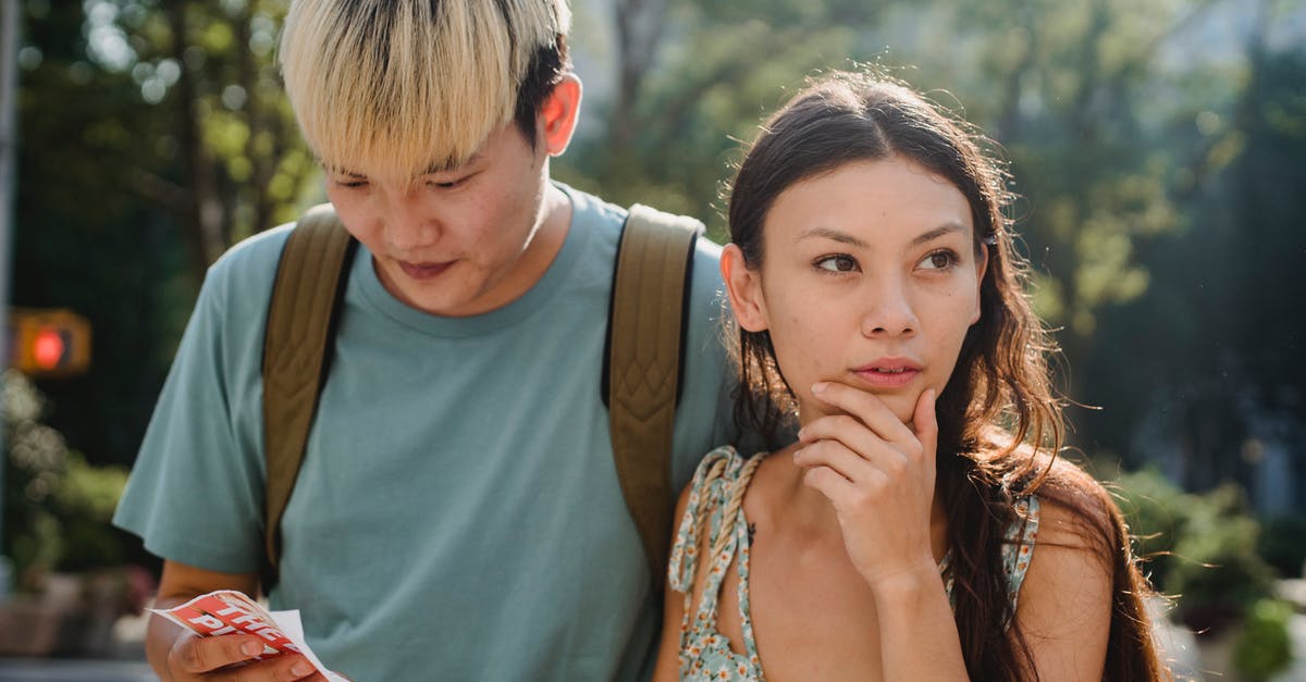 What all can I find in the End City Chests? - Confused multiracial couple searching way in map while discovering city together during summer holidays