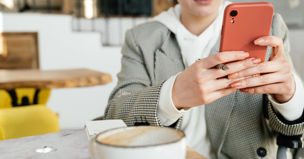 What application type and protocol do I use for port forwarding on 2WIRE? - Crop focused female in formal wear and eyeglasses browsing mobile phone while having coffee in cafeteria