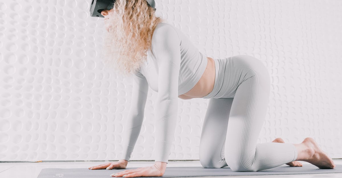 What are all the possible Accolades? - Woman in White Long Sleeve Shirt and Gray Pants Sitting on White Floor