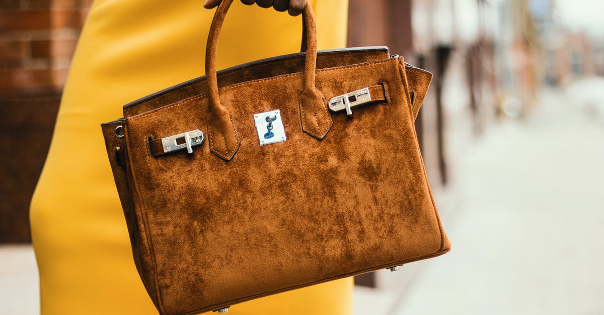 What are familia metals for? - Woman Wearing Brown Leather Tote Bag
