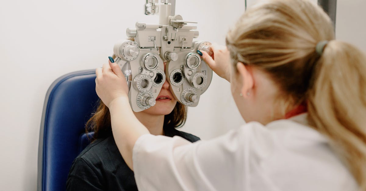 What are items that help us to get vision spells? - Unrecognizable ophthalmologist checking vision of patient What are items that help us to get vision spells? - Unrecognizable ophthalmologist checking vision of patient