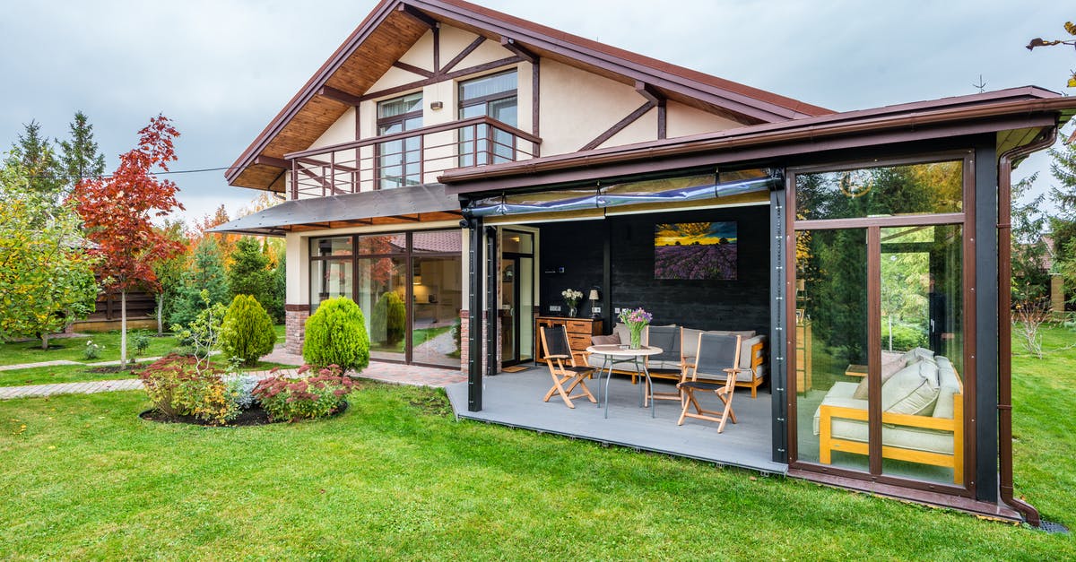 What are Private Servers? - Residential cottage with balcony and opened veranda opening view on lawn and trees growing in backyard