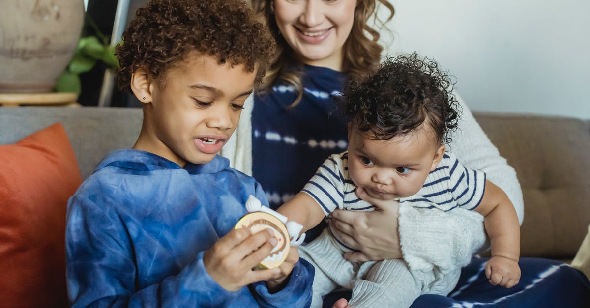 What are "torrents" in relation to gaming? - Positive mum hugging curios African American baby reaching hands to sibling playing with toy at home What are "torrents" in relation to gaming? - Positive mum hugging curios African American baby reaching hands to sibling playing with toy at home