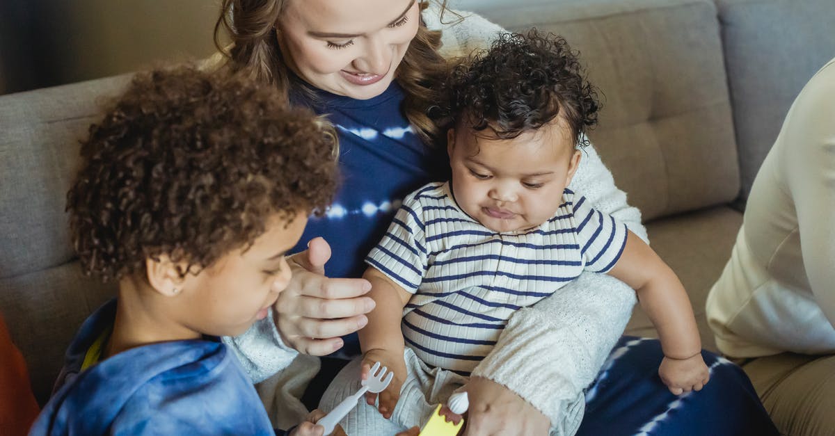 What are "torrents" in relation to gaming? - High angle of African American boy playing with toys standing near smiling mother cuddling small baby What are "torrents" in relation to gaming? - High angle of African American boy playing with toys standing near smiling mother cuddling small baby