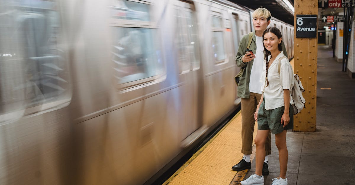 What are some rules of thumb for train lengths? - Young trendy ethnic passengers waiting for train on platform