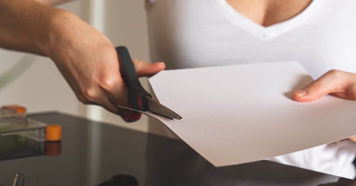 What are some tips to making sharp turns in NFS Carbon? - Woman in White Tank Top Holding Black and Silver Scissors