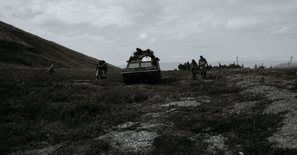 What are the avenues for attack in Sanctuary Hill? - Unrecognizable soldiers near tank during military training