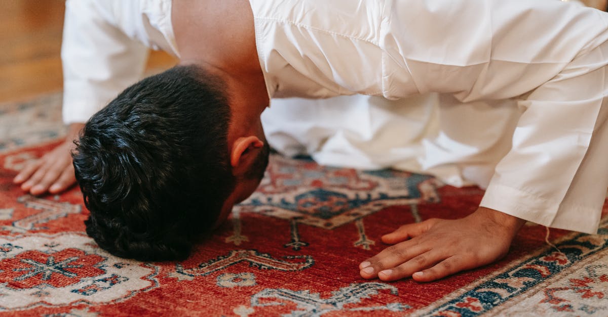 What are the benefits and disadvantages of having multiple religious heads as landed vassals? - Man in White Thobe Bowing Down on Red and Blue Rug