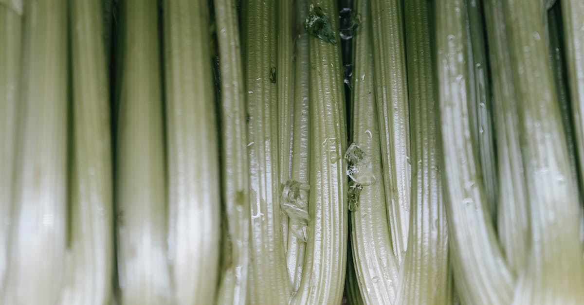 What are the benefits of fresh produce, and how long does it last? - Backdrop of raw celery with wavy leaves and thick green stems in shiny light