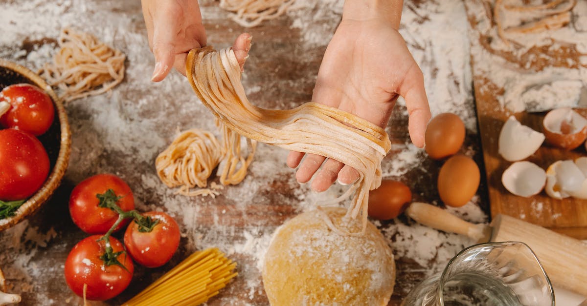 What are the benefits of fresh produce, and how long does it last? - From above of crop anonymous female demonstrating long thin noodle near table with tomatoes and eggs