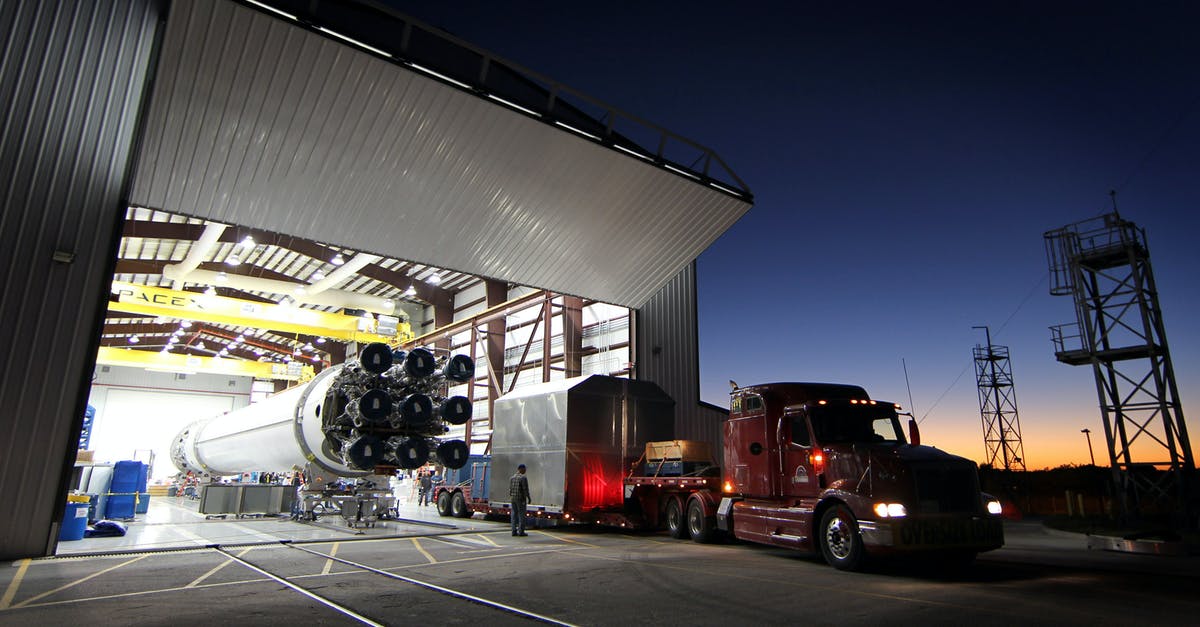 What are the benefits of having a cargo freight station? - Truck parked near hangar in rocket factory What are the benefits of having a cargo freight station? - Truck parked near hangar in rocket factory