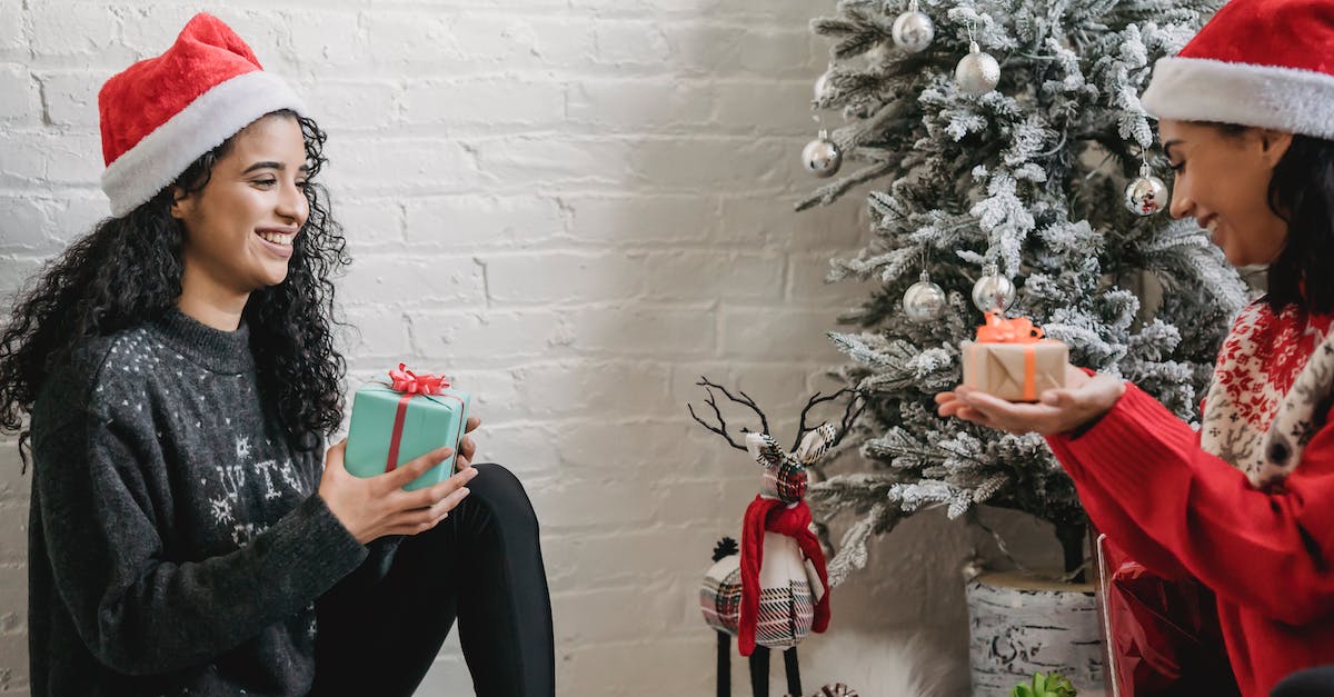 What are the best presents to give when wooing someone? - Excited ethnic friends exchanging gifts for Christmas