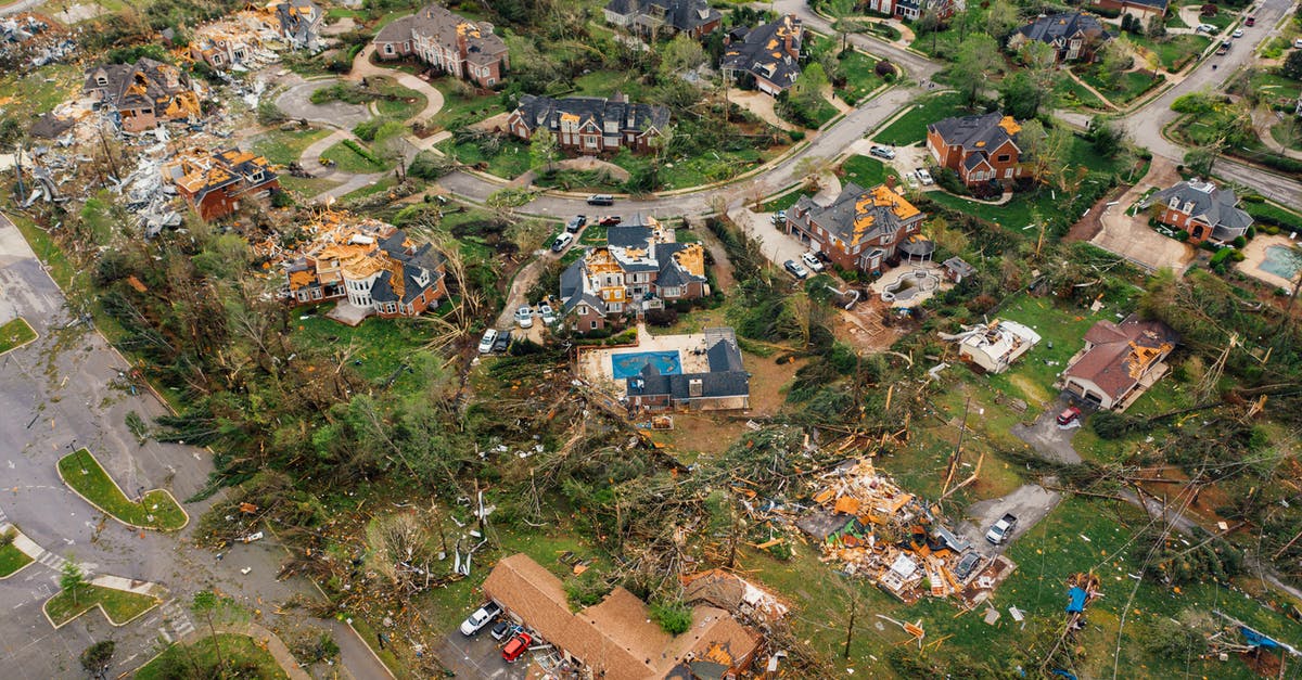 What are the consequences of destroying the USS Constitution? - Dramatic view of village houses damaged by thunderstorm