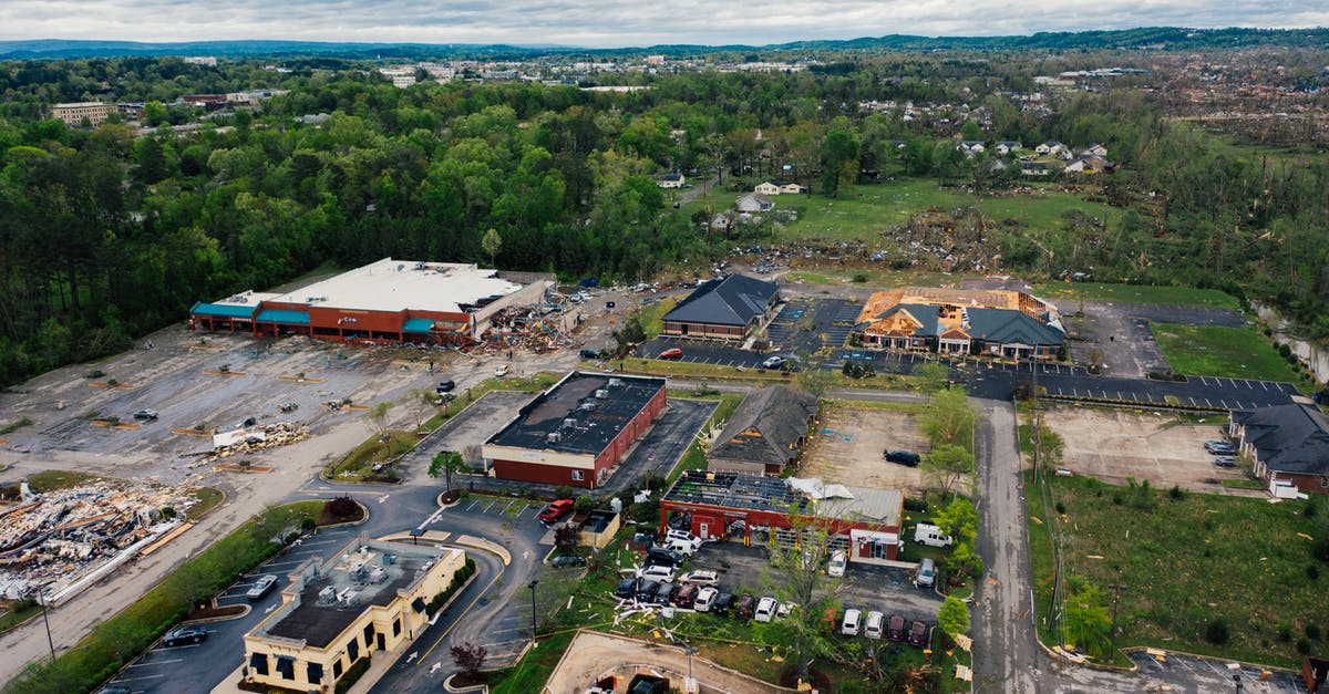 What are the consequences of destroying the USS Constitution? - Suburb area buildings with windthrown roofs after thunderstorm