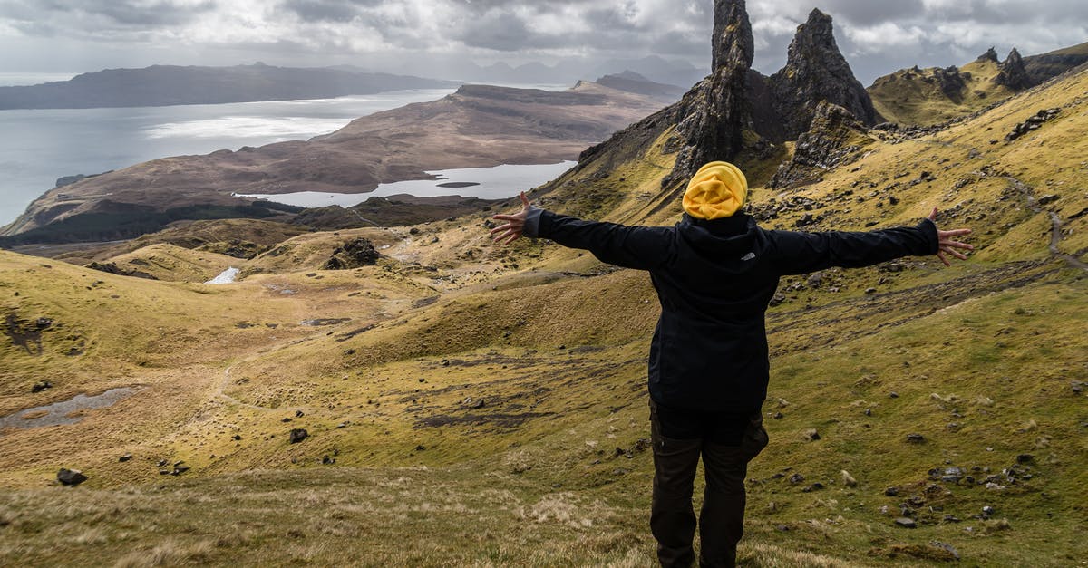 What are the consequences of travelling to the Isle of Mists? - Person Wearing Black Jacket Standing on Green Grass Field Near Lake What are the consequences of travelling to the Isle of Mists? - Person Wearing Black Jacket Standing on Green Grass Field Near Lake