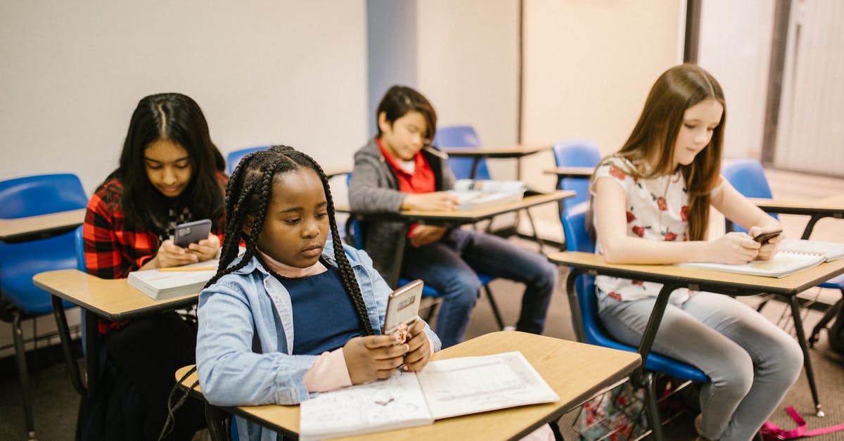 What are the consequences of using nuclear weapons against pirates or barbarians? - Students Sitting Inside the Classroom While Using Their Smartphone