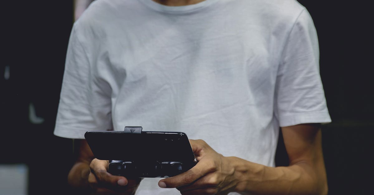 What are the differences between console and PC versions? - A Smartphone Game Controller On A Person's Hand