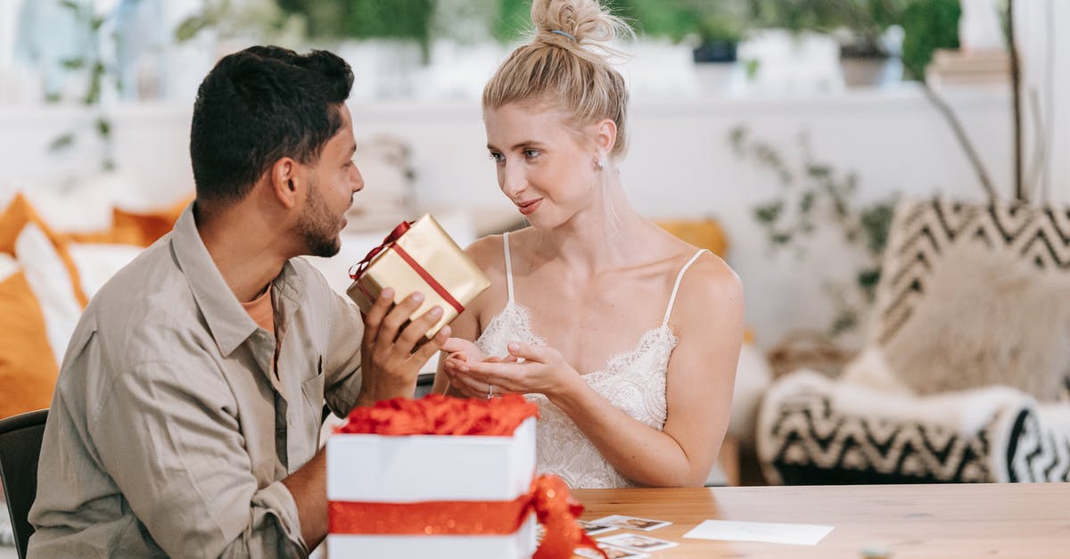 What are the downsides to giving away Migration Access? - Man and Woman Sitting at Table