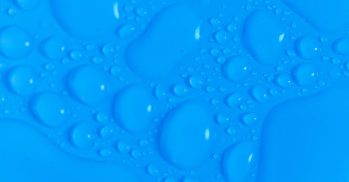 What are the drop rates for the different rarities in Loot Boxes? - Closeup top view of dark blue wet blurred background with still shiny abstract transparent fluid drops of different sizes and shapes