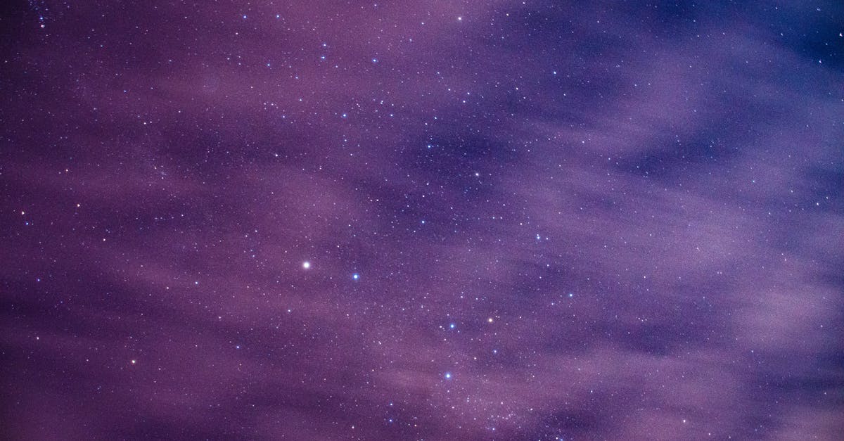 What are the effects of discovering a natural wonder? - Long exposure of cosmic background with dark night sky with glowing bright stars behind light floating clouds