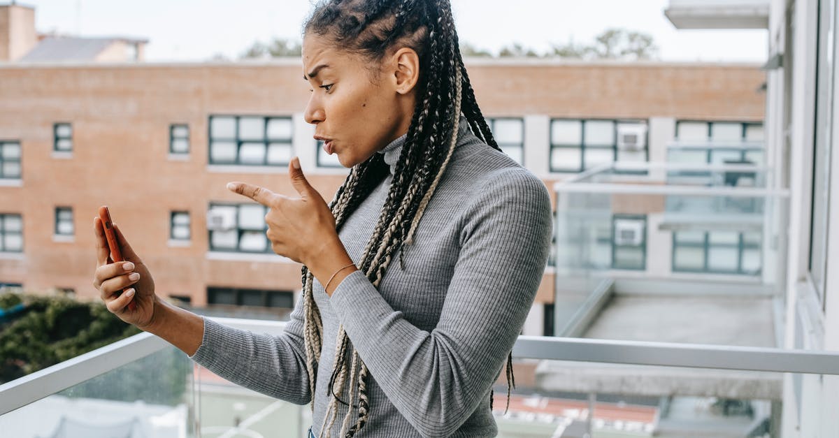 What are the hidden bonuses/penalties of hamlet stress buildings? - Side view of young furious African American woman with braids in casual outfit pointing at smartphone screen while arguing during video call standing on balcony