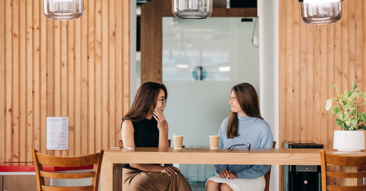 What are the long-term consequences of joining each faction? - Cheerful diverse friends talking at table with coffee in cafe