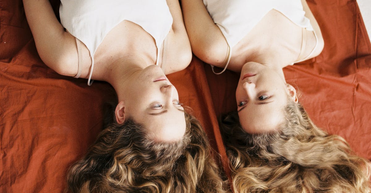 What are the long-term consequences of joining each faction? - An Upside Down Shot of Two Teens Lying and Looking at Each Other 