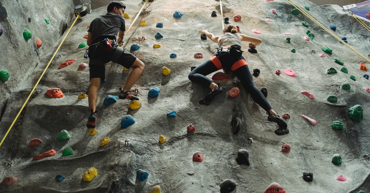 What are the missable equipment/items in Bravely Default? - From above of unrecognizable friends in sportswear training on climbing wall during workout together