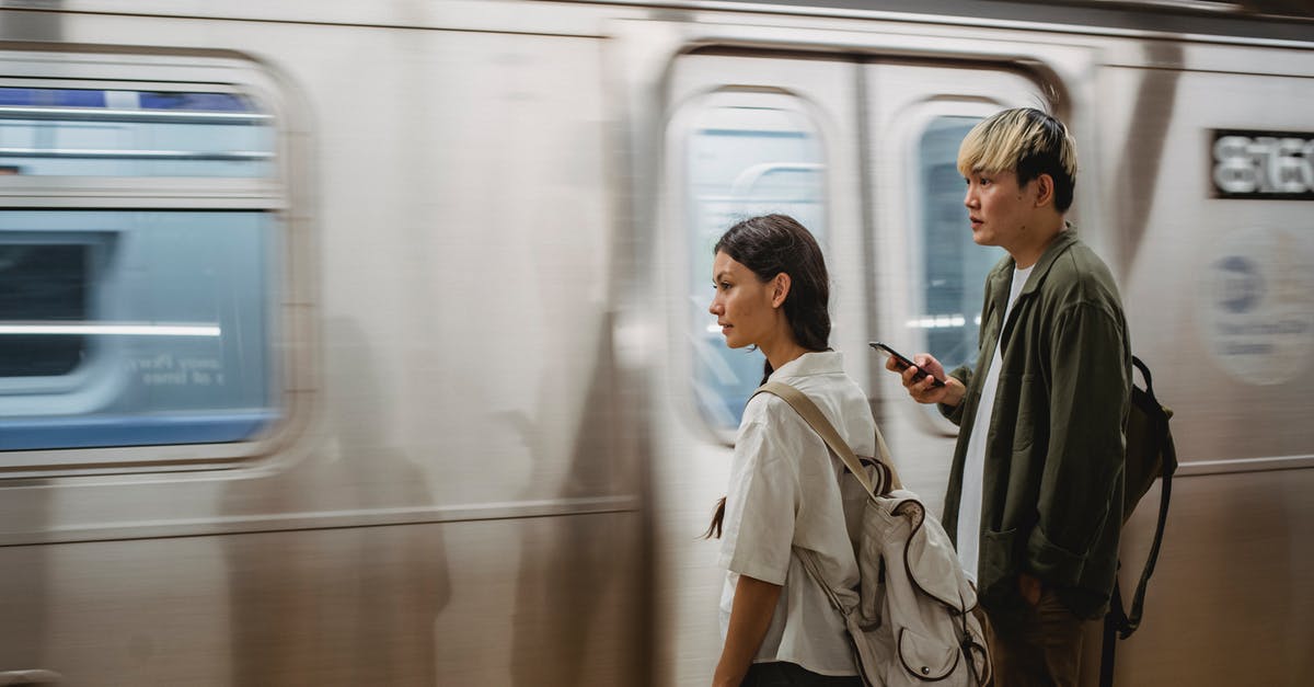 What are the passenger bonus numbers? - Calm Asian couple standing on train platform