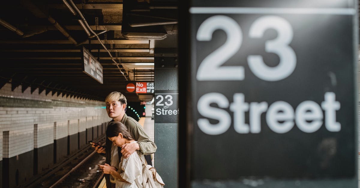 What are the passenger bonus numbers? - Asian couple standing on railroad station